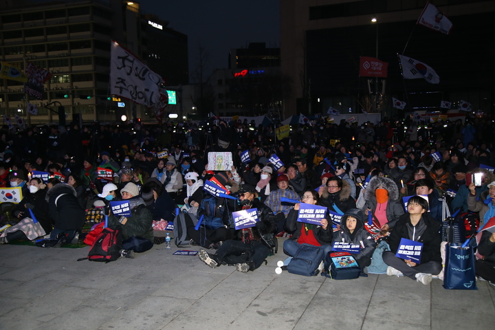 11일 열린 '2020 광화문 탈환 촛불문화제' 본 행사 시작을 앞두고 시민들이 모여 앉아 있다.