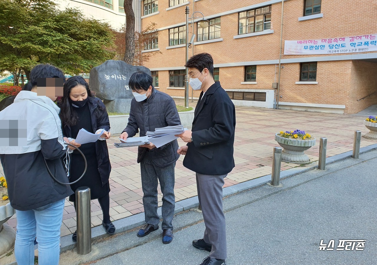 대전노은중학교 2학년 담임선생님들이 21일 오후 4시쯤 학교 후문진입로에 직접 나와 온라인 개학으로 대면하지 못하는 학생들과 인사를 나누며, 원격수업에 필요한 학습지를 드라이브스루(DRIVE THROUGH) 및 워크스루(WORK THROUGH) 방식으로 학습지를 배부하고 있다./ⓒ이현식 기자