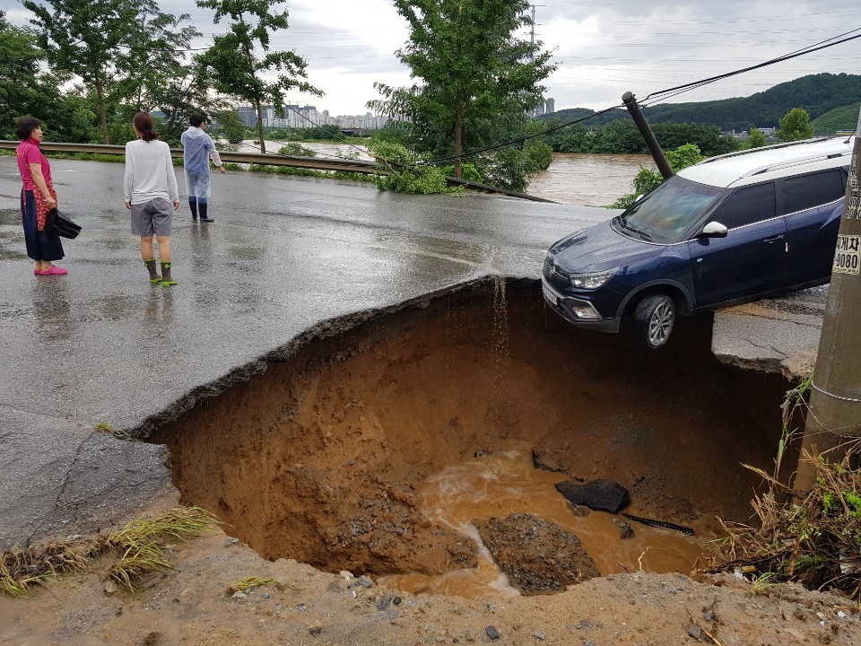 충남 아산시 배방읍 갈매리 인근 도로가 호우피해로 씽크홀이 형성됐다. 4일 오전 SUV차량이 위태롭게 걸쳐 있다./ⓒ김형태 기자