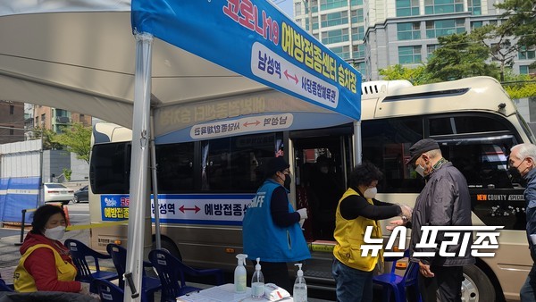 자원봉사자들이 버스 탑승하려는 어르신의 손에 소독제를 뿌려주고 있다. ⓒ 김은경 기자