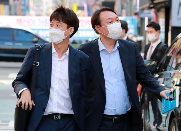 국민의힘 이준석 대표와 윤석열 전 검찰총장이 25일 오후 서울 광진구 건대 맛의거리에서 '치맥회동'을 하기 위해 음식점으로 향하고 있다. 야권 대선 주자 윤석열 전 검찰총장이 드루킹 댓글조작  김경수 경남지사 구속과  관련해  "문재인 대통령이 답하고 책임져야 한다"라고 주장했다.  연합뉴스