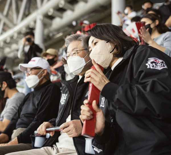 야구  관람중  김혜경씨가 이재명 후보에게 다정하게 귓속말을 하고 있다.(사진=이재명 후보 열린캠프)